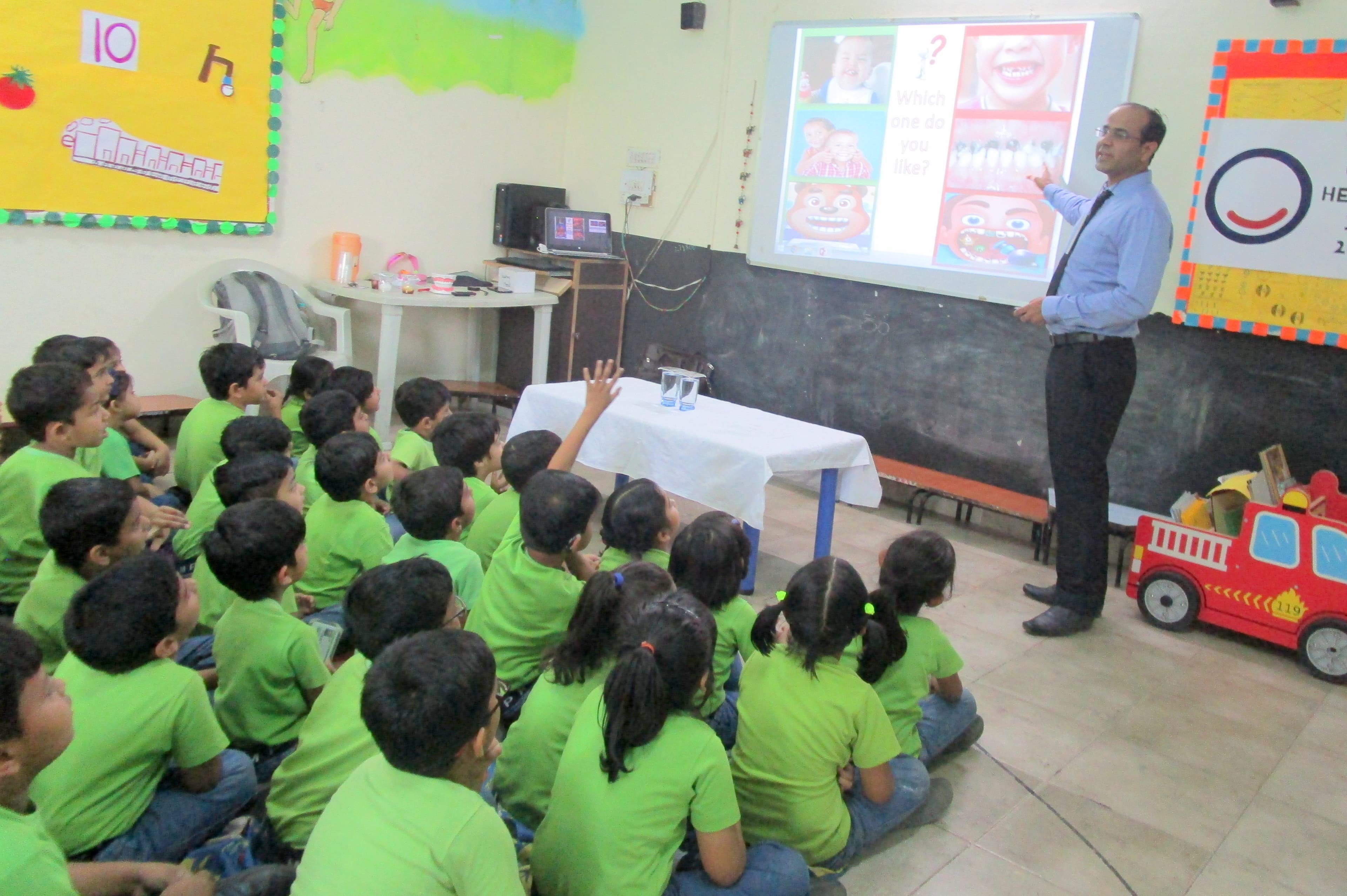 Dental educator leading an oral-health session for schoolchildren